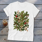 White t-shirt with a vintage botanical illustration of pine needles, holly, and berries.