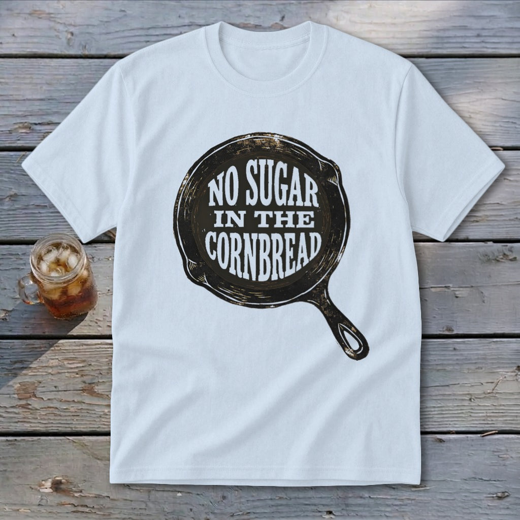 White t-shirt with graphic of a cast iron skillet and text "NO SUGAR IN THE CORNBREAD".