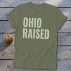 Olive green t-shirt with large light beige text reading "OHIO RAISED".