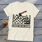 Cream t-shirt with woodpile graphic and "Stacked for the Season" text.