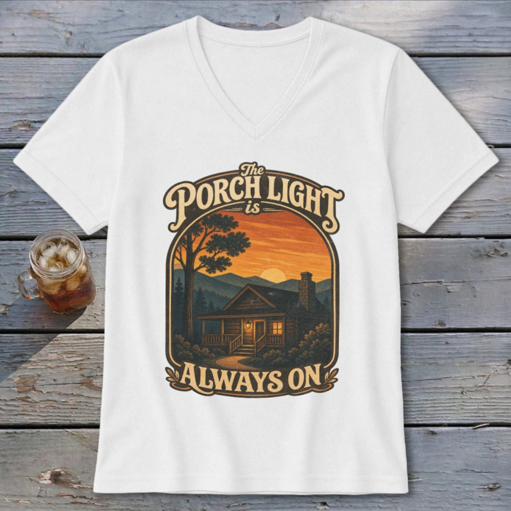 White t-shirt with graphic "The Porch Light is Always On" over a cabin at sunset.