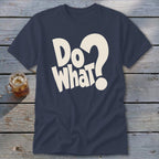 A dark blue t-shirt printed with the white text Do What and a question mark lies on a wooden background.