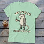 Light green t-shirt with a possum holding coffee and text that says "DON'T MIND ME I'M JUST SULLED UP".