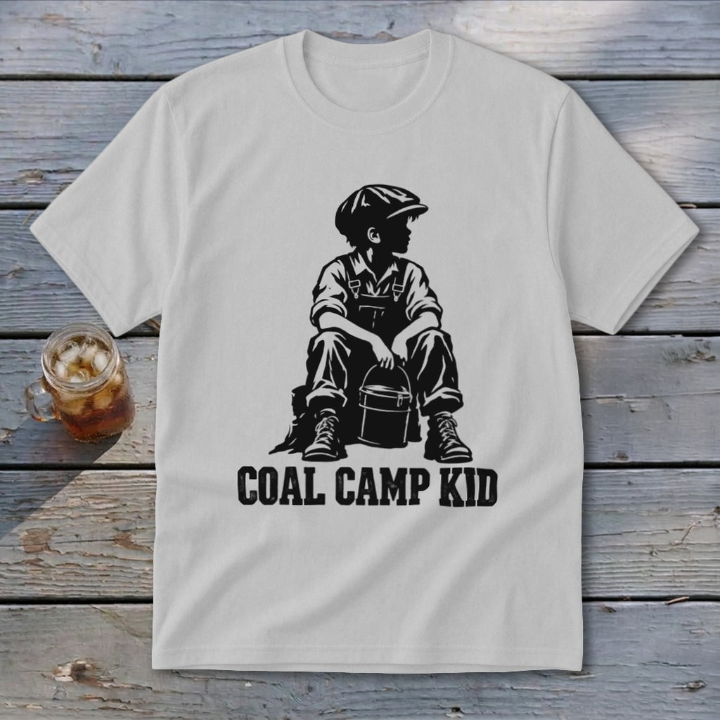 White t-shirt with black graphic of boy in overalls and cap holding a bucket, "Coal Camp Kid" text.