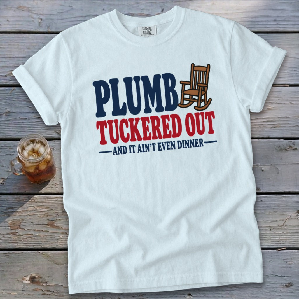 White t-shirt with "PLUMB TUCKERED OUT AND IT AIN'T EVEN DINNER" text and rocking chair graphic.