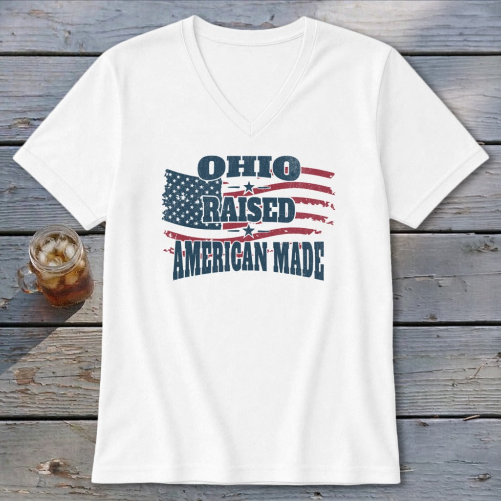 A white V-neck t-shirt featuring a graphic with an American flag and the text Ohio Raised American Made.