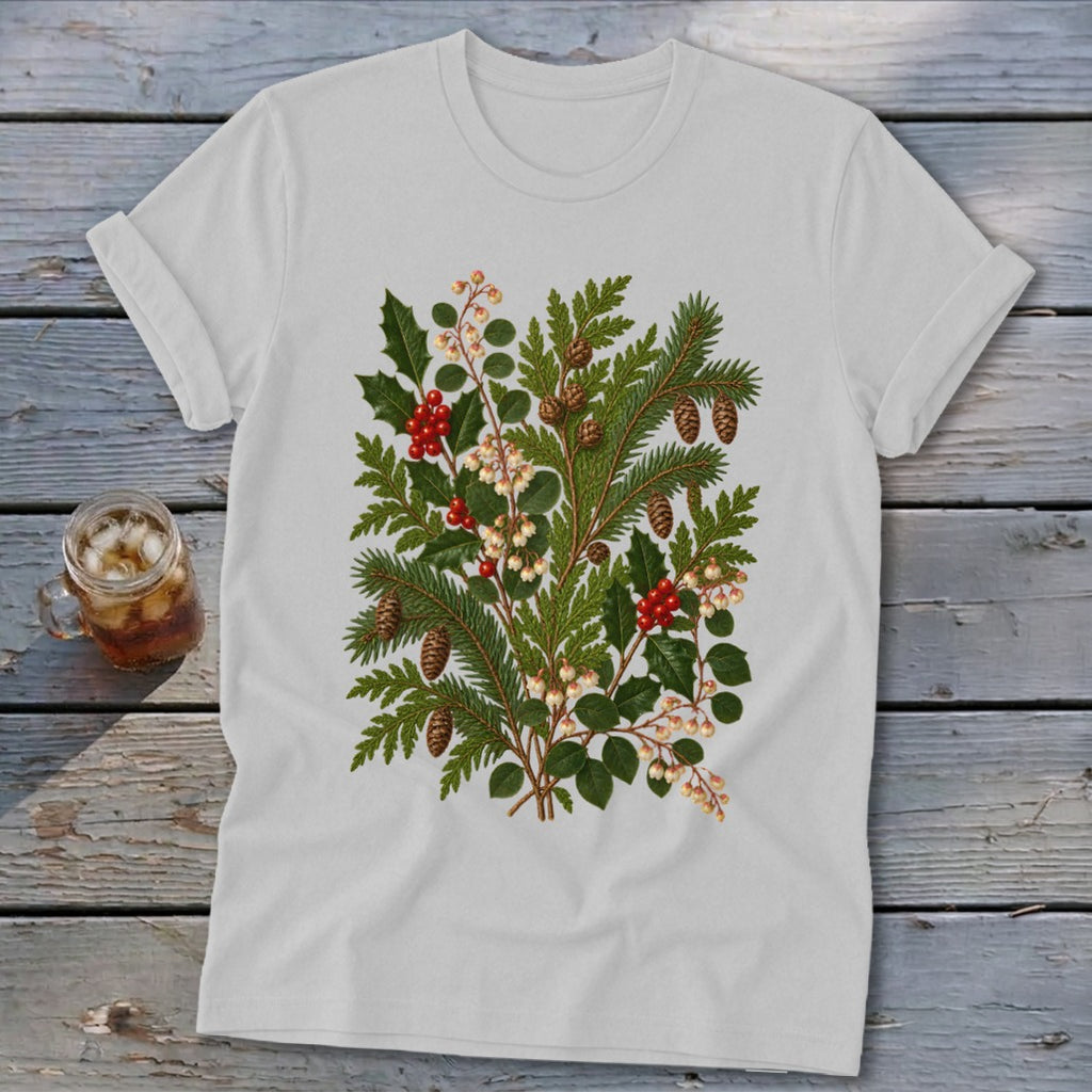 White t-shirt with a botanical illustration of holly, pine, and berries.