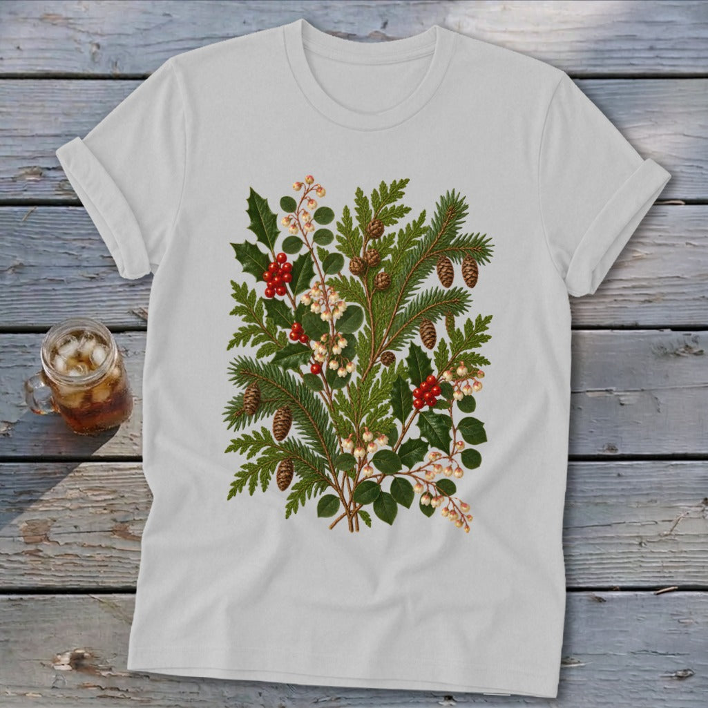 White t-shirt with a botanical illustration of holly, pine, and berries.