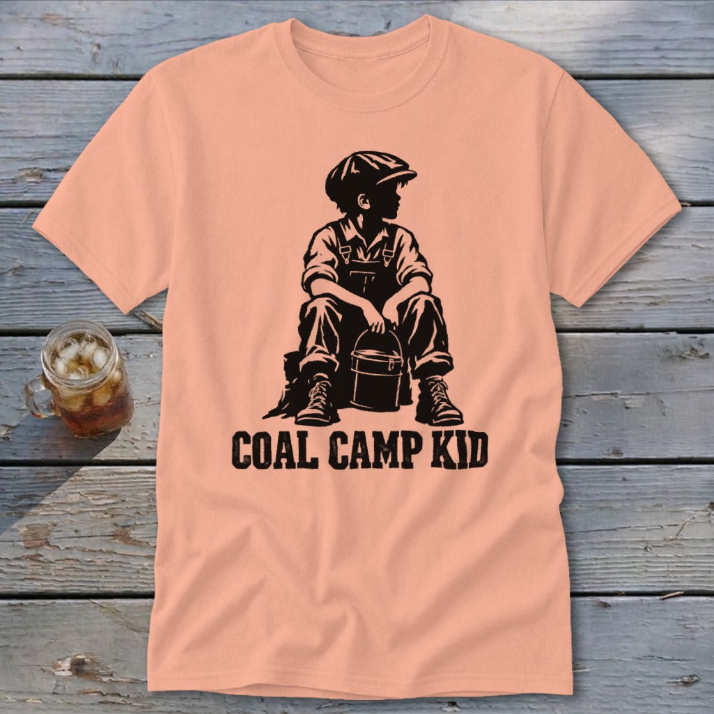 Peach t-shirt with black graphic of a boy holding a bucket and text "COAL CAMP KID".