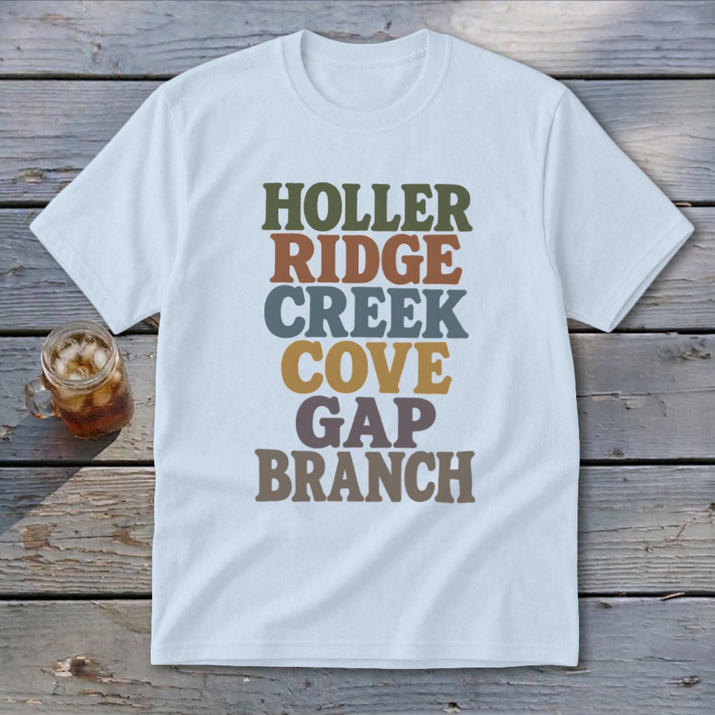 A light blue crewneck t-shirt featuring stacked multicolored text reading HOLLER RIDGE CREEK COVE GAP BRANCH.
