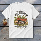 White t-shirt with graphic of a dog under a red wagon, saying "Pretty as a speckled pup".