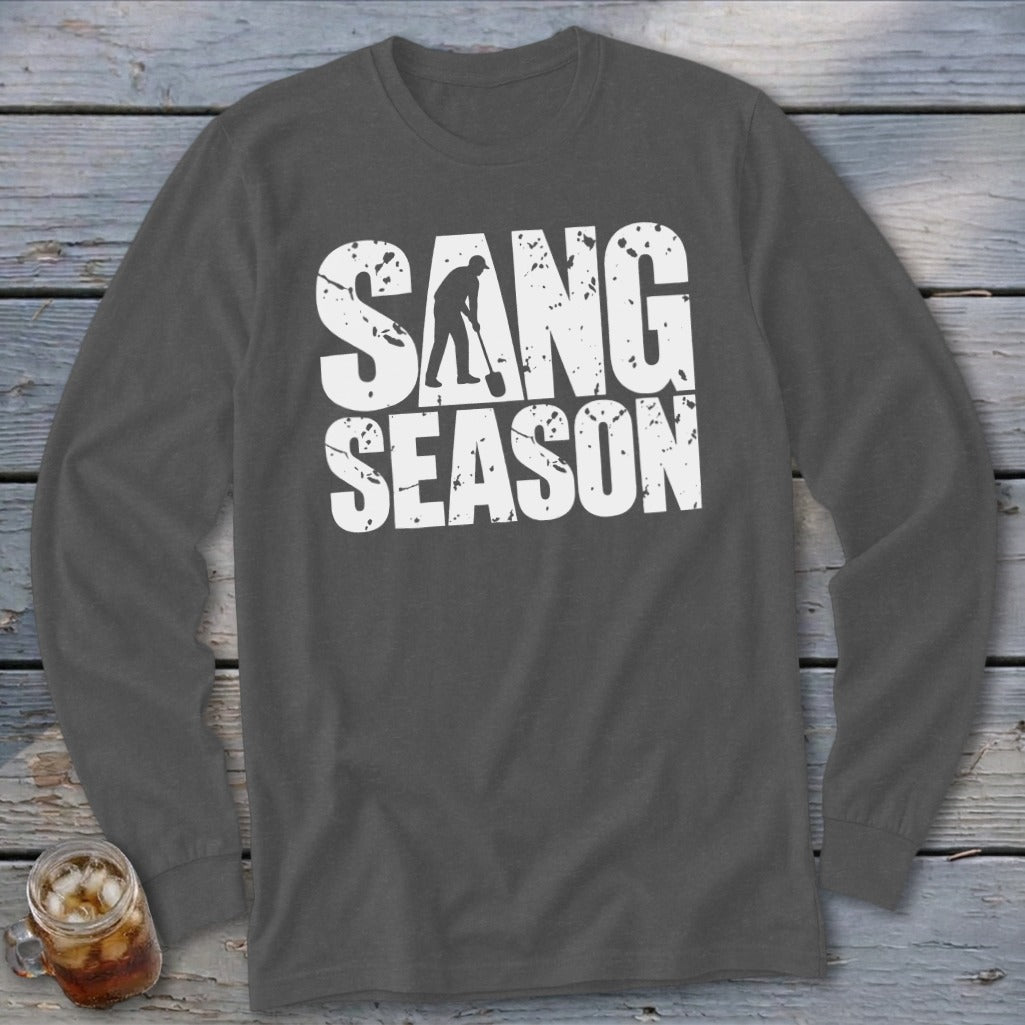 A dark gray long-sleeve t-shirt with white distressed text reading "SANG SEASON" and a silhouette of a person digging.