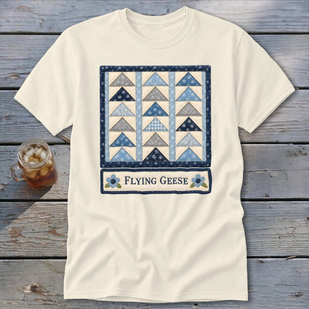 Cream t-shirt with a blue quilt pattern and the words "Flying Geese".