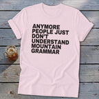 Light pink t-shirt with black text that reads "Anymore people just don't understand mountain grammar".