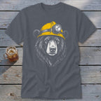 Bear wearing a yellow hard hat with a headlamp graphic on a dark grey t-shirt.