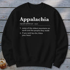 A black crewneck sweatshirt printed with white dictionary-style text defining Appalachia against a wooden background.