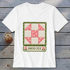 White t-shirt with "Shoo Fly" text and a pink and white floral quilt block design.