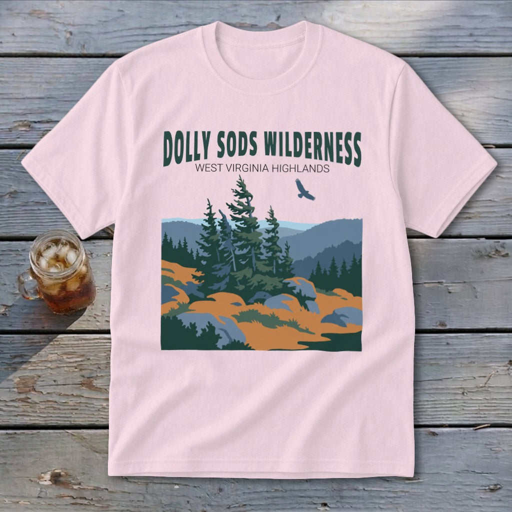 A light pink t-shirt displays graphic text reading Dolly Sods Wilderness above an illustrated mountain landscape.