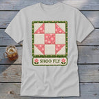 White t-shirt with a Shoo Fly quilt block design and text.