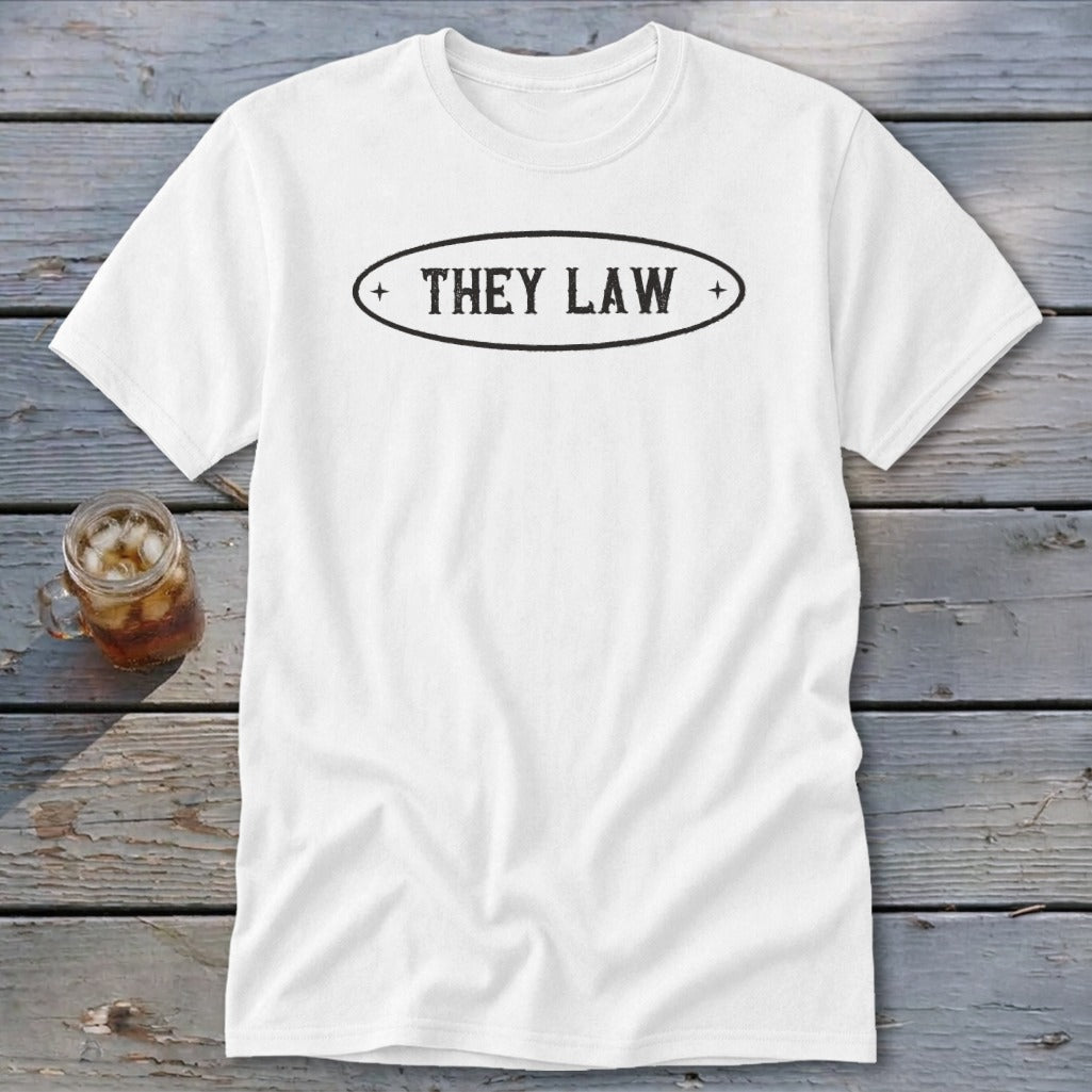 White t-shirt with black oval logo reading "THEY LAW".