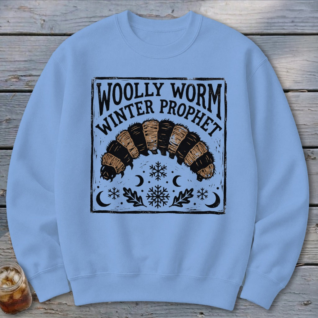 Light blue crewneck sweatshirt featuring a black graphic of a woolly worm and text reading Woolly Worm Winter Prophet.