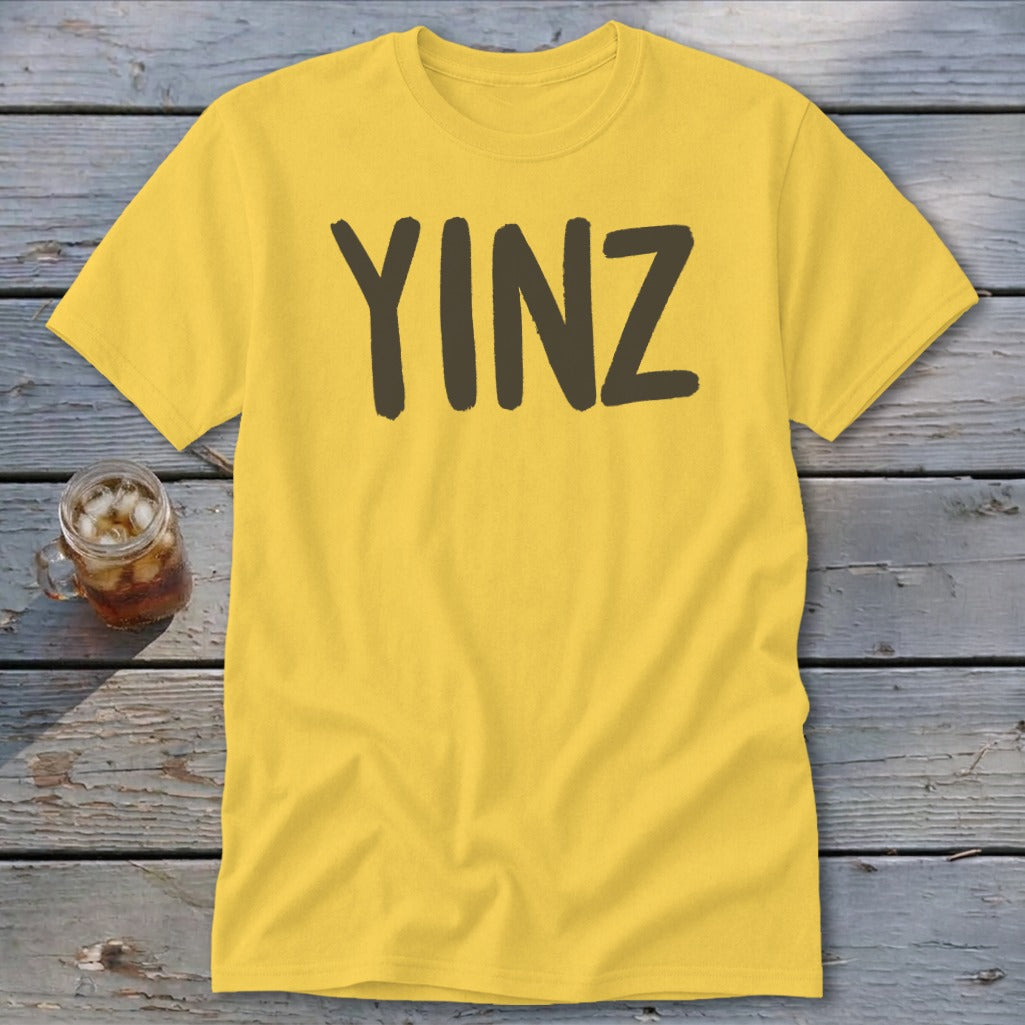 Yellow t-shirt with "YINZ" printed in dark brown letters.