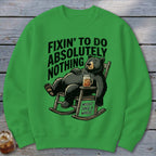 Green crewneck sweatshirt featuring a graphic of a bear relaxing in a rocking chair with text.