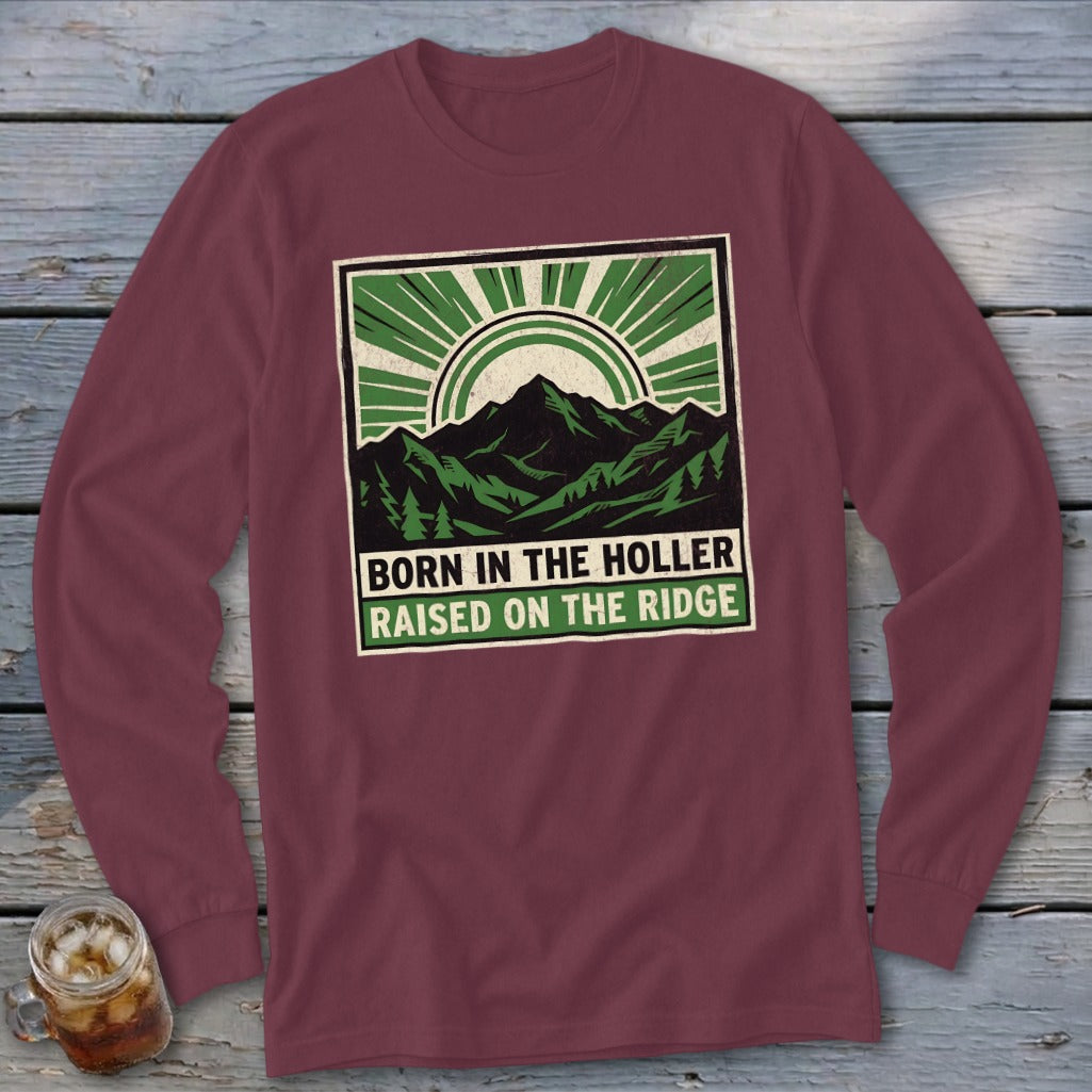 Maroon long-sleeve t-shirt with a green graphic of mountains, trees, and text reading BORN IN THE HOLLER RAISED ON THE RIDGE.