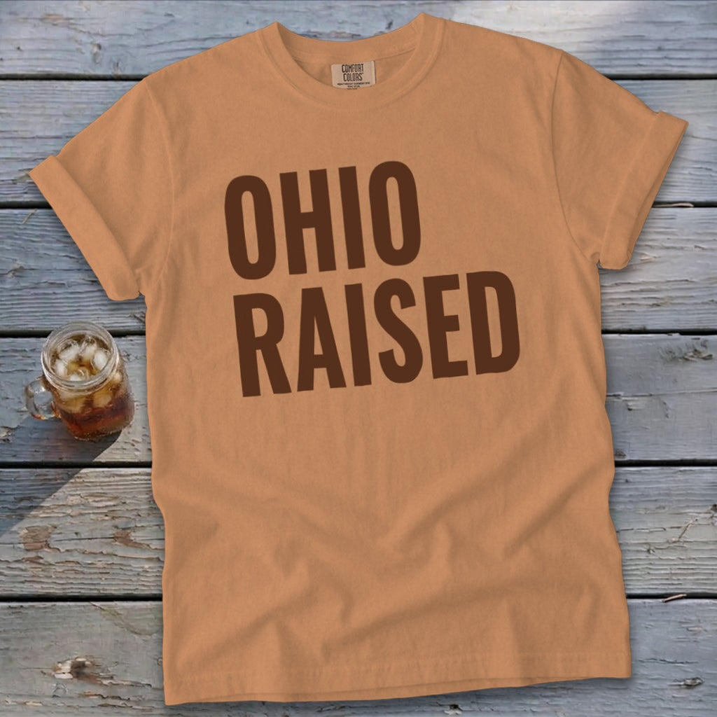 Orange t-shirt with brown "OHIO RAISED" text and a glass of iced tea.