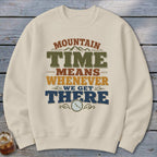 Cream sweatshirt with "Mountain Time Means Whenever We Get There" graphic and clock.