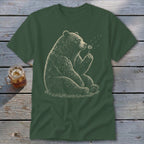 Bear blowing on a dandelion puff on a dark green t-shirt.
