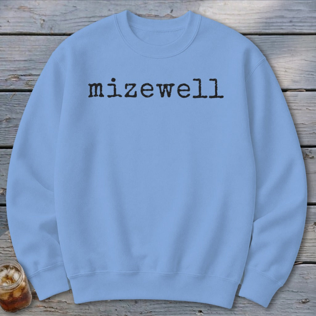 Light blue crewneck sweatshirt with "mizewell" in black typewriter font.
