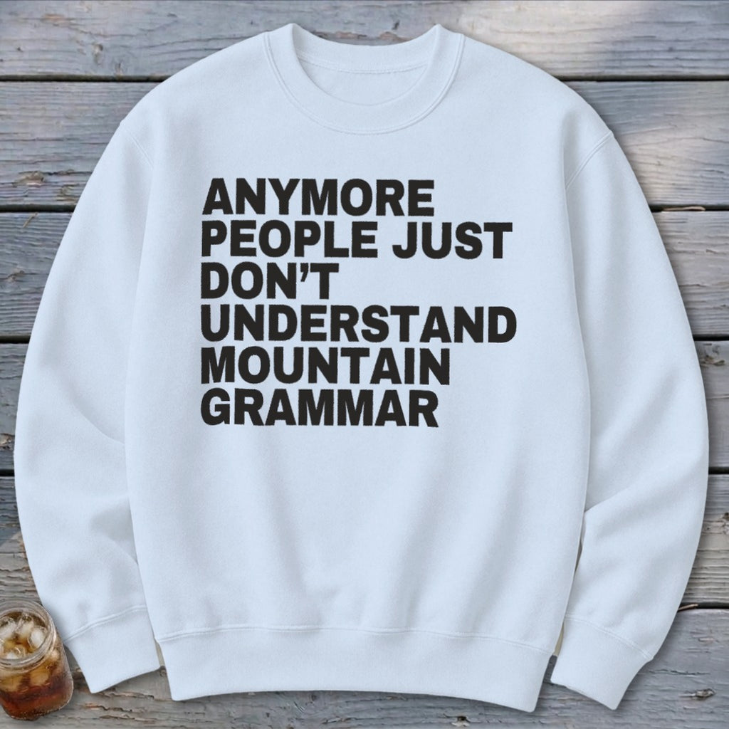 White sweatshirt with black text that reads "Anymore people just don't understand mountain grammar."