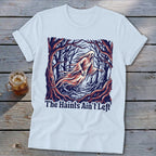 White t-shirt with a ghost in a forest and the text "The Haints Ain't Left".