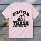 Pink t-shirt with black text and oil pump graphic: "Oilfield Trash and Proud of It".