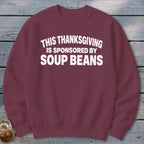 Maroon crewneck sweatshirt with white text reading "This Thanksgiving is sponsored by soup beans."