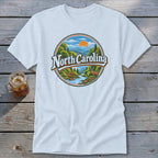 White t-shirt with a circular graphic of North Carolina landscape, mountains, deer, and river.