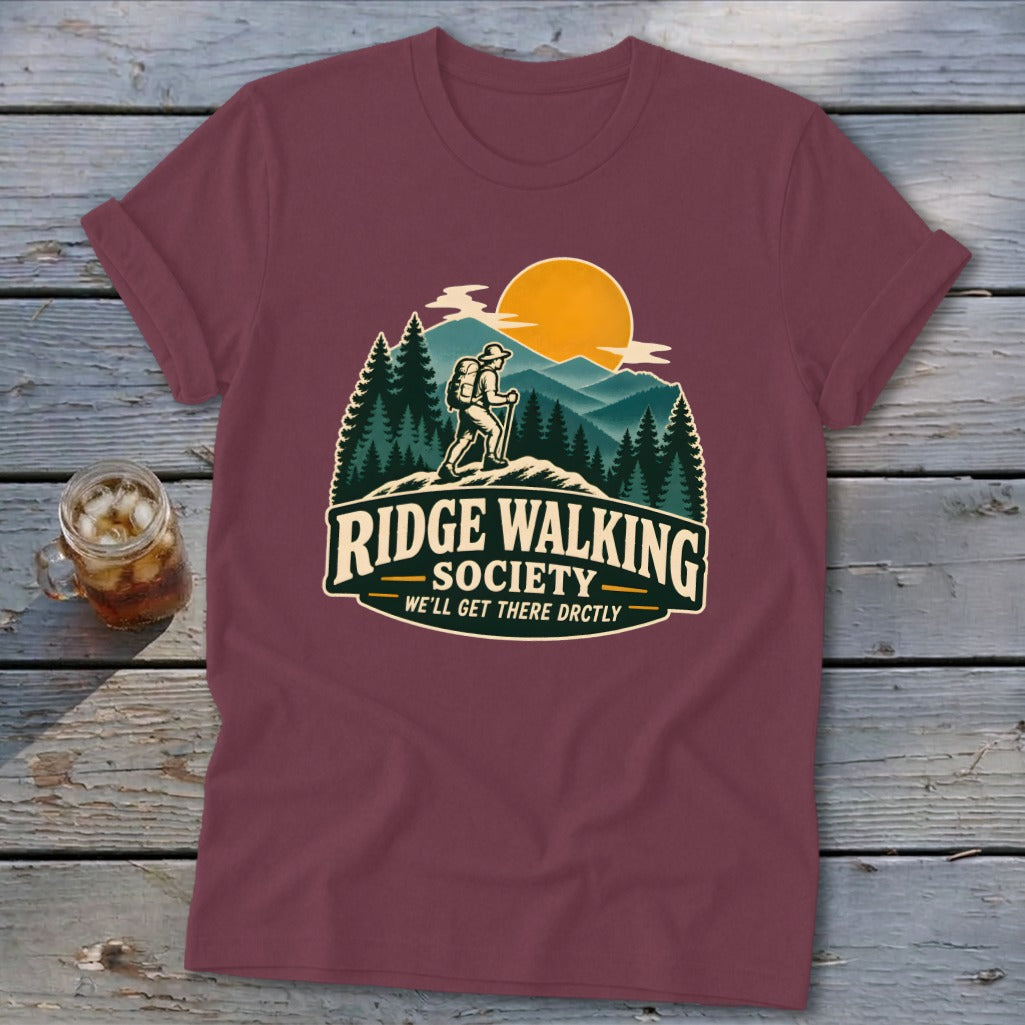 Maroon t-shirt with a graphic of a hiker on a ridge with text "Ridge Walking Society".