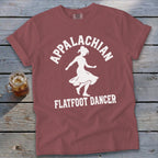 Muted red t-shirt with a white graphic of a dancer and the text Appalachian Flatfoot Dancer.