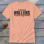 Peach t-shirt with black text reading "THESE HOLLERS know my name"
