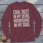 A maroon long-sleeve t-shirt with white distressed text that reads COAL DUST IN MY VEINS MOUNTAINS IN MY SOUL.
