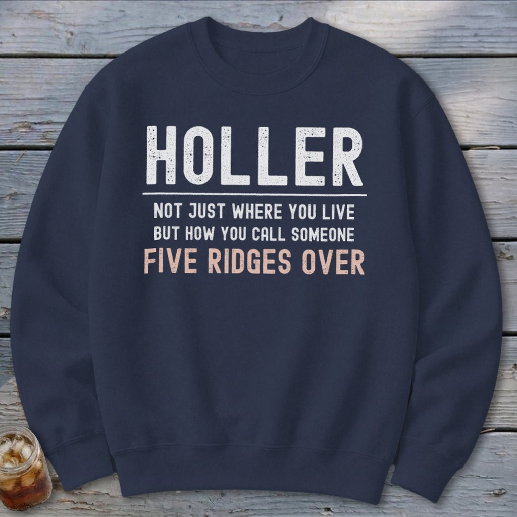 Navy sweatshirt with white and pink text: Holler, not just where you live but how you call someone five ridges over.