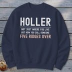 Navy sweatshirt with white and pink text: Holler, not just where you live but how you call someone five ridges over.