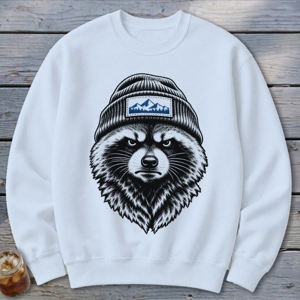 A white crewneck sweatshirt features a black-and-white graphic of a raccoon wearing a beanie.