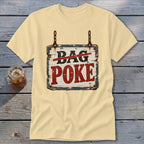 Light yellow t-shirt featuring a hanging wooden sign graphic with text reading Bag Poke.