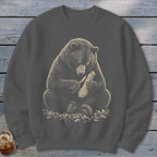 Bear sitting and carving wood with a knife, surrounded by wood shavings.