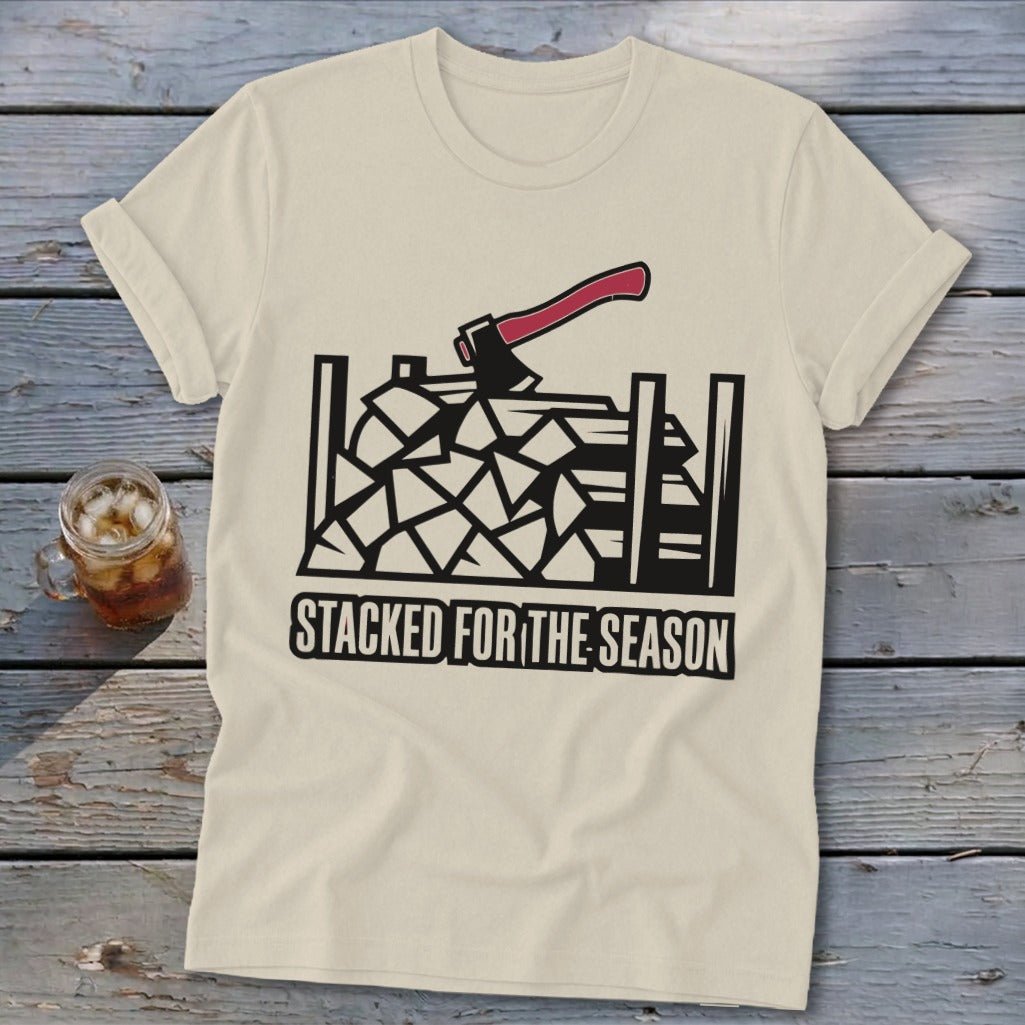 Cream t-shirt with graphic of axe over stacked firewood and text "STACKED FOR THE SEASON".