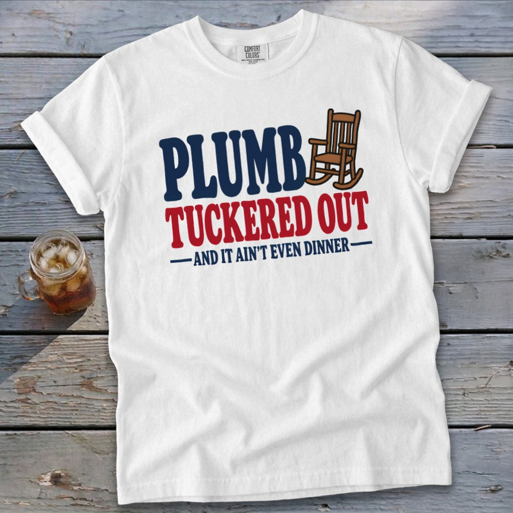 White t-shirt with "PLUMB TUCKERED OUT AND IT AIN'T EVEN DINNER" text and rocking chair graphic.