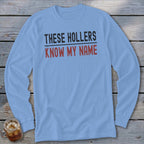 Light blue long sleeve shirt with "THESE HOLLERS KNOW MY NAME" printed on it.