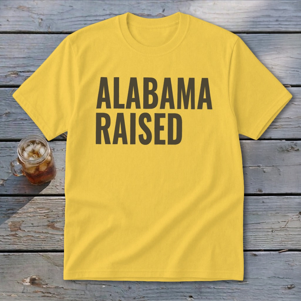 Yellow t-shirt with "ALABAMA RAISED" in dark text.